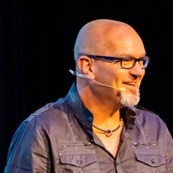 Justin Herald speaking on stage