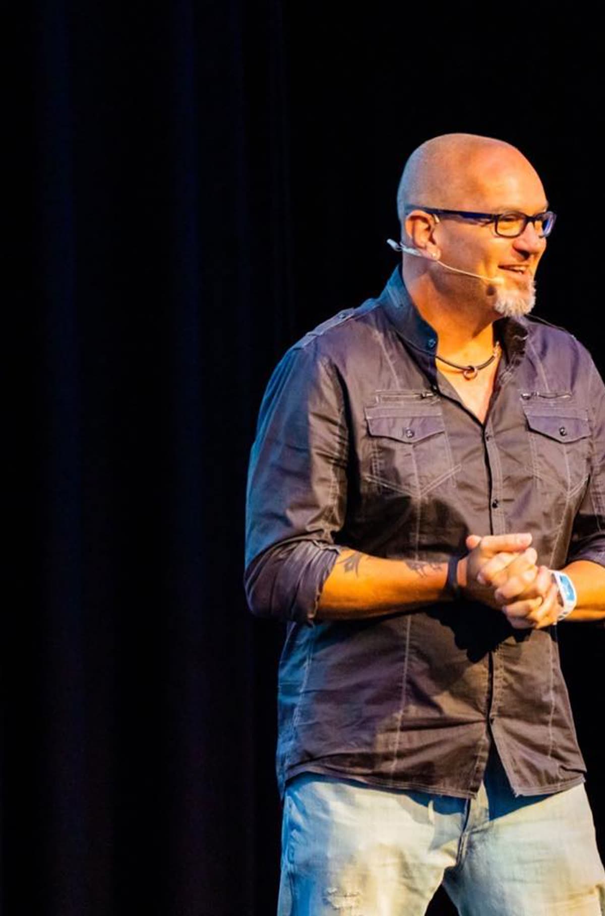 Justin Herald speaking on stage